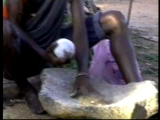 Salu Kadelya begins grinding medicines on a rock